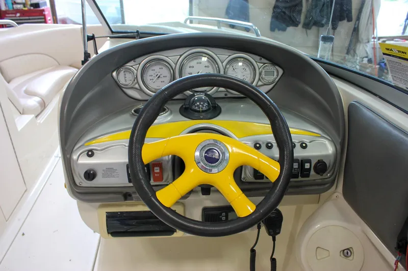 Slide: The Image of Steering wheel and dashboard of 2007 Azure AZ228 boat with yellow accents. - 18