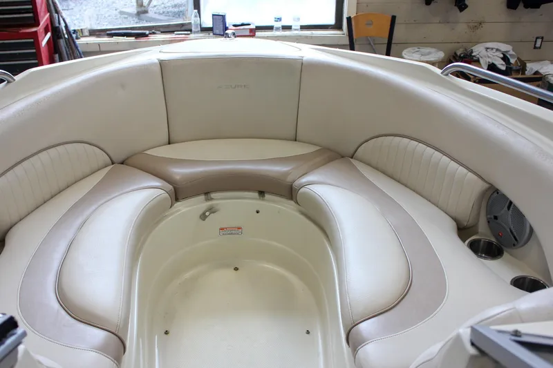 Slide: The Image of Luxurious seating area of a 2007 Azure AZ228 boat, featuring beige and cream upholstery. - 24