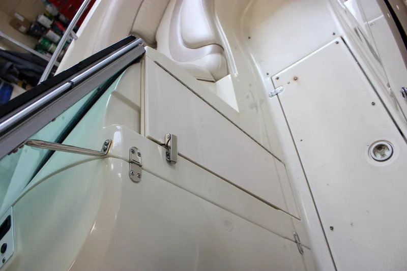 Slide: The Image of Interior of 2007 Azure AZ228 boat, featuring white seating and storage compartments. - 33