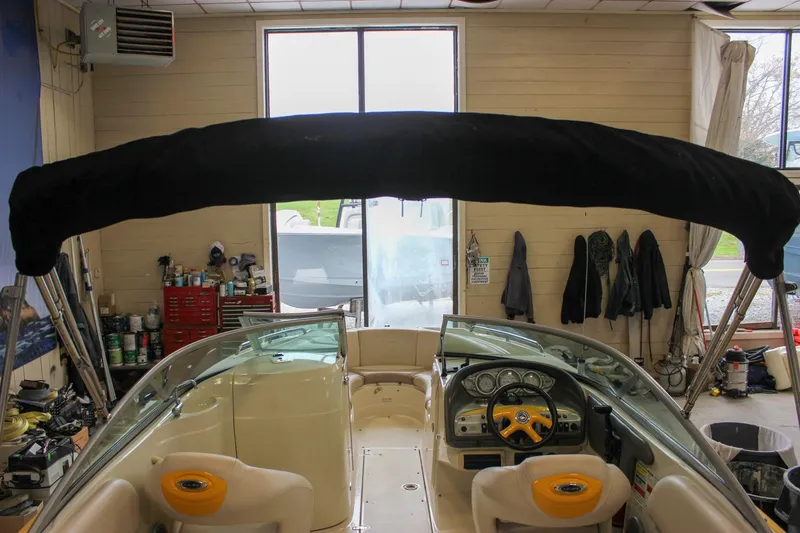 Slide: The Image of 2007 Azure AZ228 boat interior with black canopy in a workshop setting. - 37
