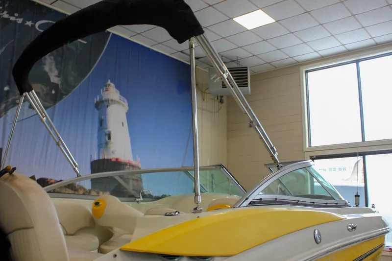 Slide: The Image of Yellow and white Azure AZ228 boat indoors, lighthouse mural in background. - 38