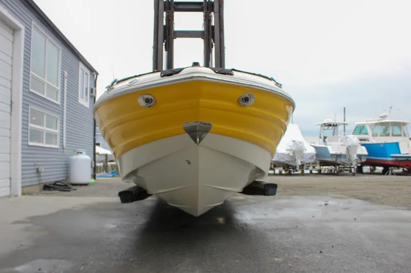 Slide: The Image of Yellow Azure AZ228 boat from 2007 on a dock, surrounded by other boats. - 4