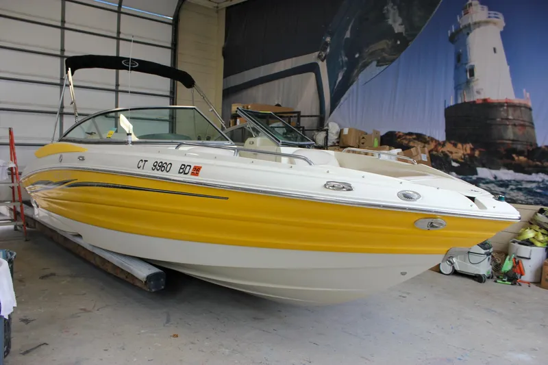 Slide: The Image of Yellow 2007 Azure AZ228 boat in a garage with lighthouse mural. - 40