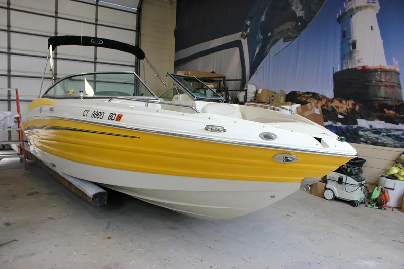 Slide: The Image of Yellow and white 2007 Azure AZ228 boat in a garage with a lighthouse mural. - 41