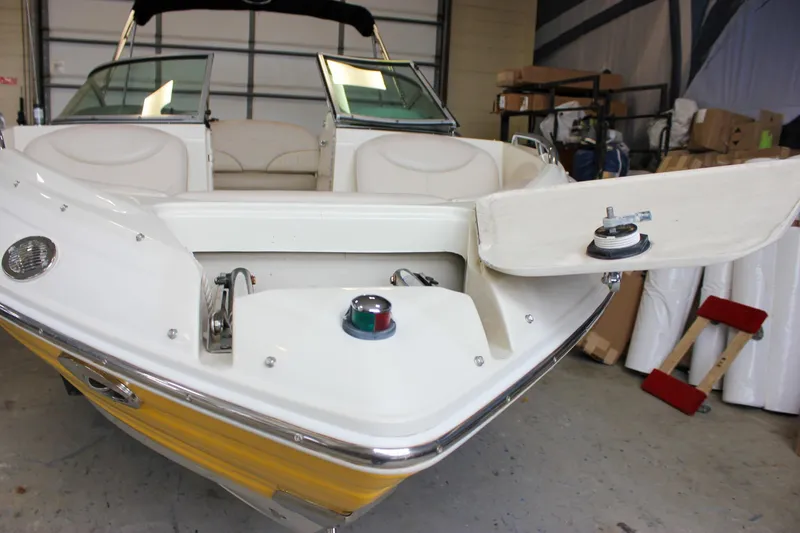 Slide: The Image of 2007 Azure AZ228 boat in garage, open storage compartment, white and yellow design. - 42