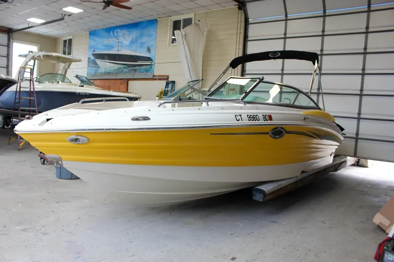 Slide: The Image of Yellow Azure AZ228 boat from 2007 in a garage setting. - 44