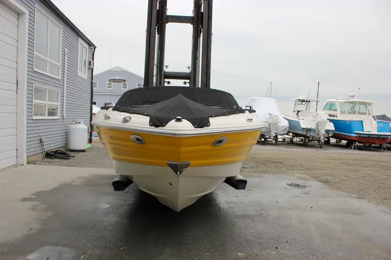 Slide: The Image of 2007 Azure AZ228 boat with yellow hull, docked near marina buildings. - 50