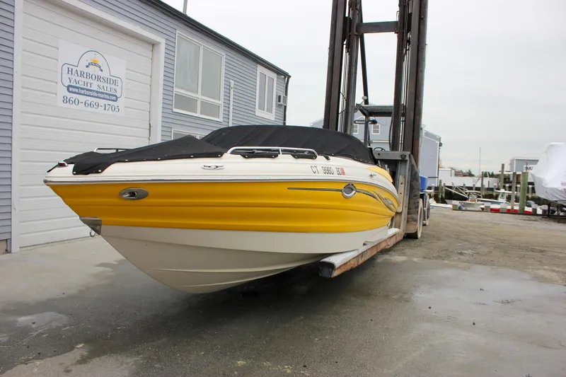 Slide: The Image of Yellow 2007 Azure AZ228 boat at Harborside Yacht Sales, covered and lifted by forklift. - 51