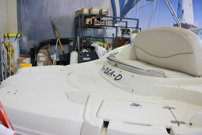 Slide: The Image of 2007 Azure AZ228 boat in storage, featuring a white deck and cushioned seating. - 7