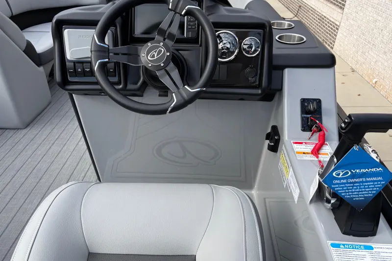 Slide: The Image of 2026 Veranda Relax VR22RC boat dashboard with steering wheel and control panel. - 8