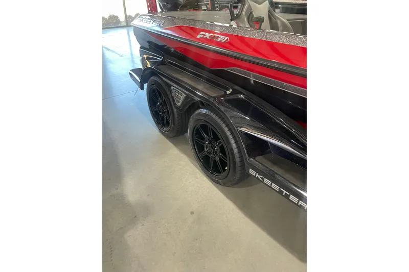 Slide: The Image of 2022 Skeeter FXR20 Apex boat with sleek black and red design on trailer. - 11