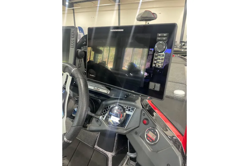 Slide: The Image of 2022 Skeeter FXR20 Apex boat dashboard with Humminbird electronics and steering wheel. - 15