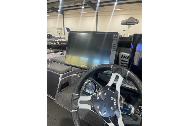 Slide: The Image of 2022 Skeeter FXR20 Apex boat dashboard with Garmin display and steering wheel. - 16