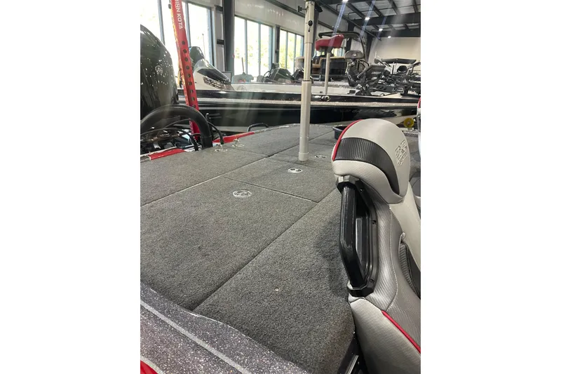 Slide: The Image of 2022 Skeeter FXR20 Apex boat interior with gray carpet and seating. - 18