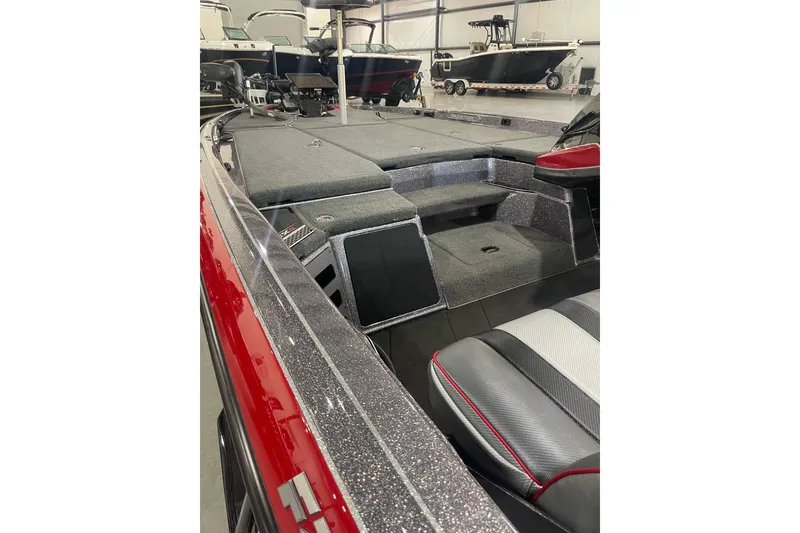 Slide: The Image of 2022 Skeeter FXR20 Apex boat interior with sleek seating and storage compartments. - 25