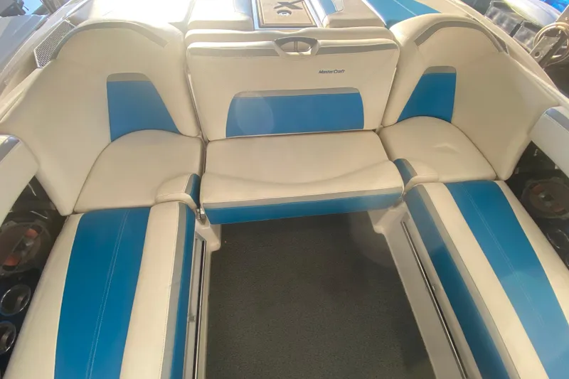 Slide: The Image of 2019 MasterCraft XStar boat interior with blue and white seating. - 10