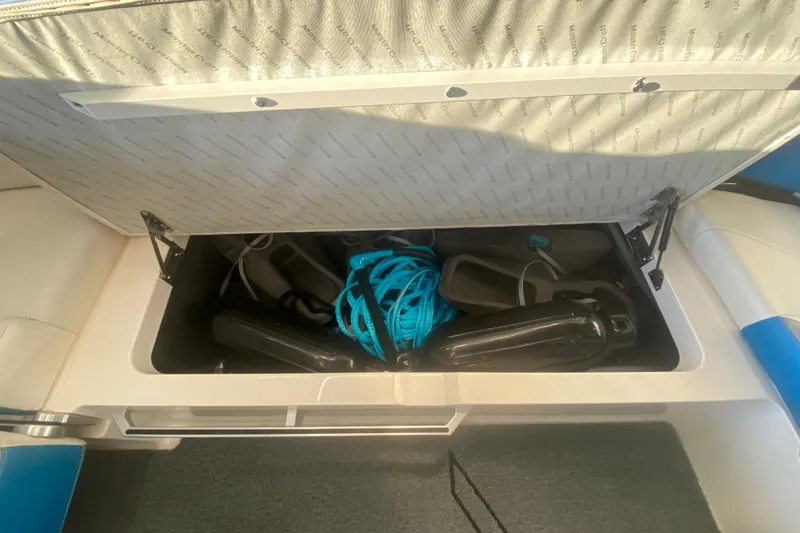 Slide: The Image of 2019 MasterCraft XStar storage compartment with blue rope and black fenders. - 13