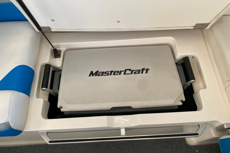 Slide: The Image of 2019 MasterCraft XStar boat storage compartment with branded cooler. - 14