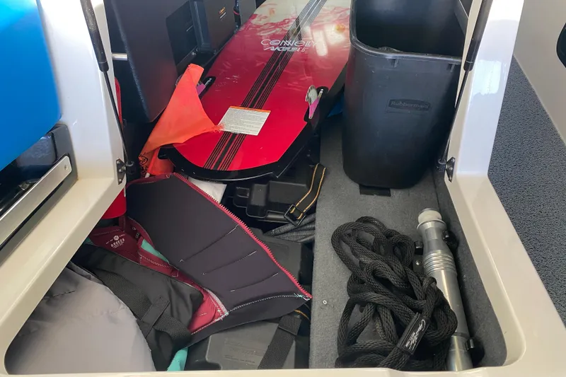 Slide: The Image of 2019 MasterCraft XStar storage with wakeboard, life vest, and boating gear. - 15