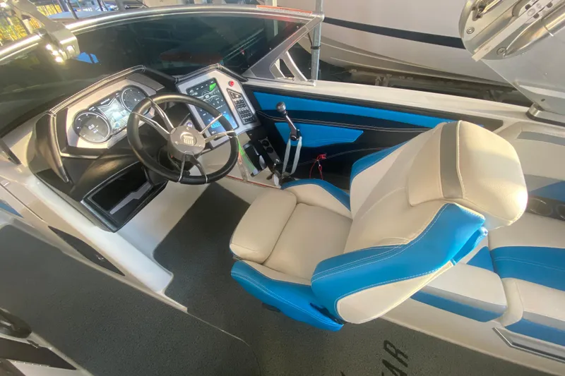 Slide: The Image of 2019 MasterCraft XStar boat interior with steering wheel and dashboard controls. - 17