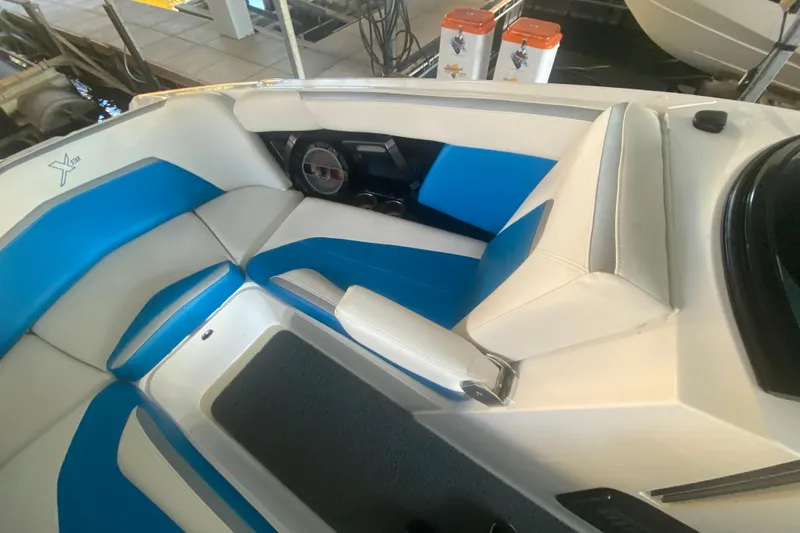Slide: The Image of 2019 MasterCraft XStar boat interior with blue and white seating, showcasing modern design. - 24
