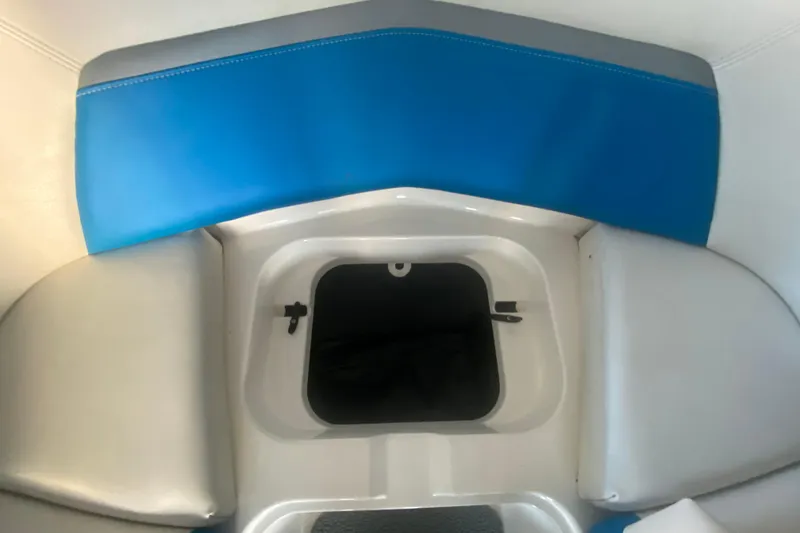 Slide: The Image of 2019 MasterCraft XStar boat interior with blue and gray seating and storage compartment. - 25