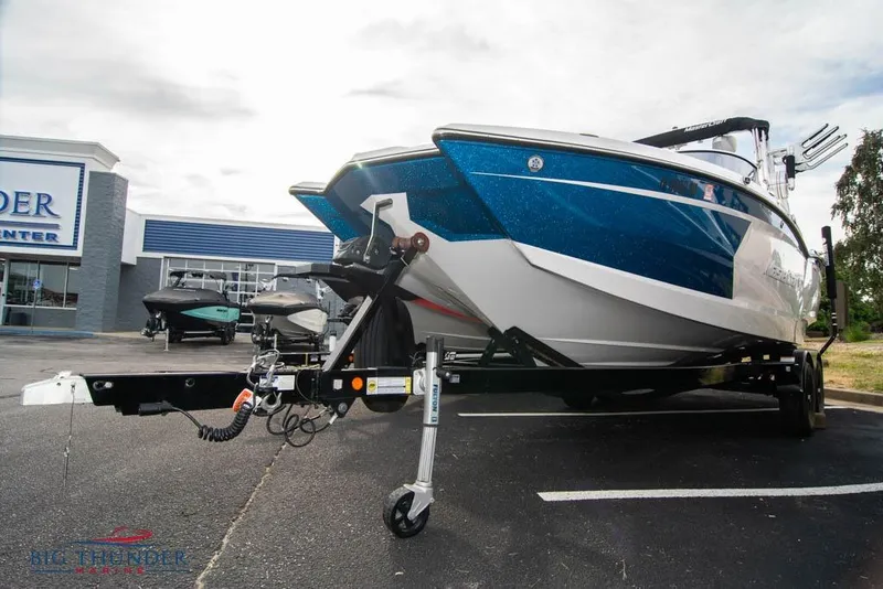 Slide: The Image of 2019 MasterCraft XStar boat on trailer at dealership parking lot. - 40