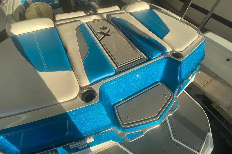 Slide: The Image of 2019 MasterCraft XStar boat interior with blue and white seating. - 6