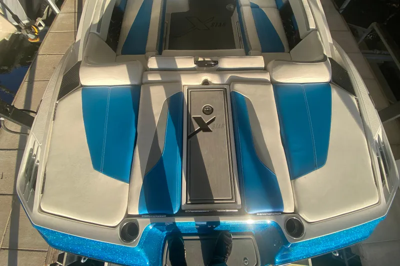 Slide: The Image of 2019 MasterCraft XStar boat interior with blue and white seating. - 7