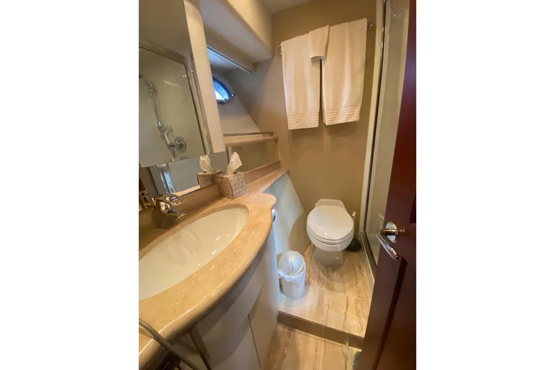 Slide: The Image of 2005 Pacific Mariner 65 Diamond yacht cruising on a scenic waterway with bridge and cityscape. - 11