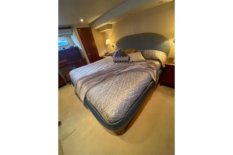 Slide: The Image of 2005 Pacific Mariner 65 Diamond yacht cruising on a scenic lake with a bridge in the background. - 12