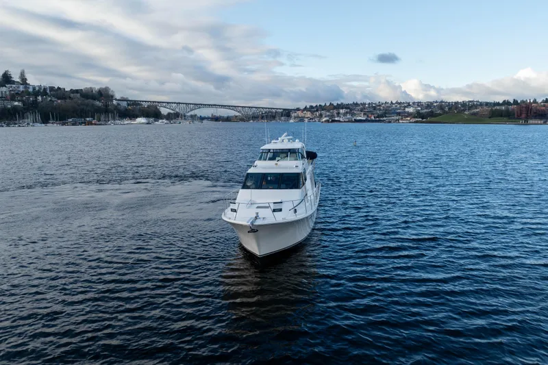 Slide: The Image of 2005 Pacific Mariner 65 Diamond yacht cruising on a scenic lake with a bridge in the background. - 14