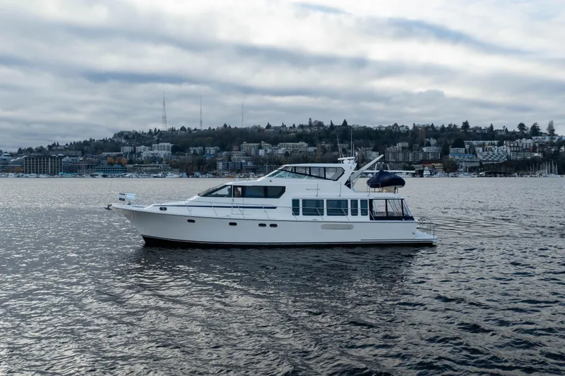 Slide: The Image of 2005 Pacific Mariner 65 Diamond yacht on water with cityscape background. - 17