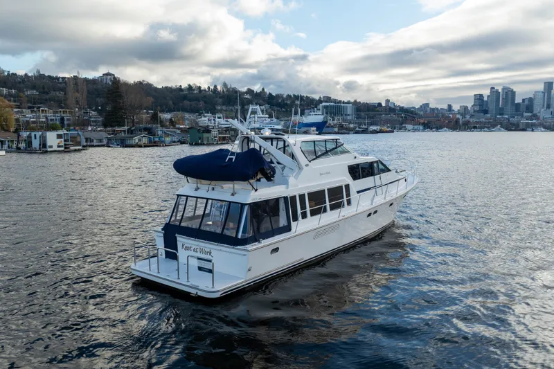 Slide: The Image of 2005 Pacific Mariner 65 Diamond yacht cruising near city skyline on a cloudy day. - 21