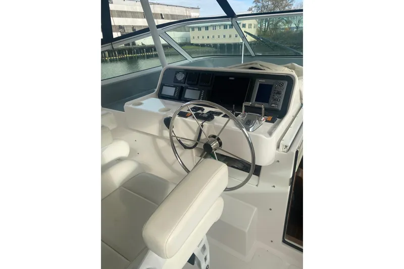 Slide: The Image of 2005 Pacific Mariner 65 Diamond yacht on water with city skyline in background. - 5