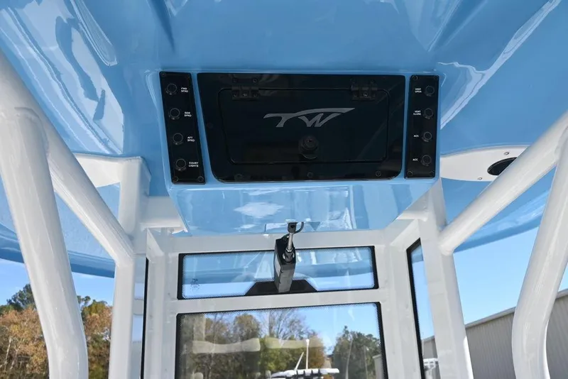 Slide: The Image of 2026 Tidewater 232 CC Adventure boat console with blue accents and control panel. - 10