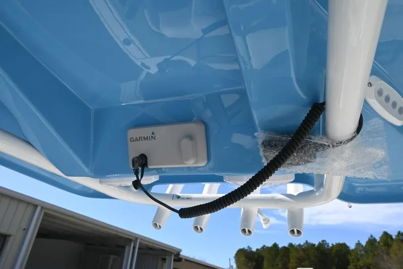 Slide: The Image of 2026 Tidewater 232 CC Adventure boat with Garmin equipment, blue hull, and white framework. - 11