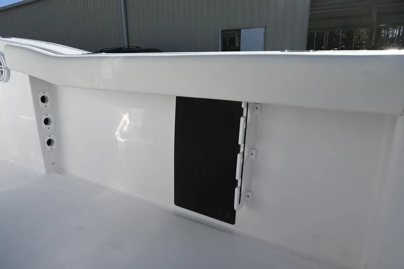Slide: The Image of 2026 Tidewater 232 CC Adventure boat interior detail with storage compartment. - 15