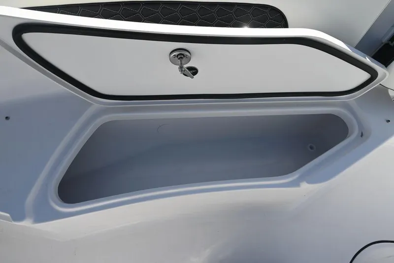 Slide: The Image of Storage compartment of 2026 Tidewater 232 CC Adventure boat, open with visible interior. - 23