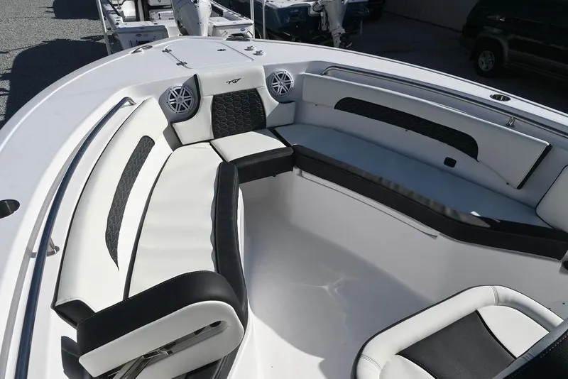 Slide: The Image of 2026 Tidewater 232 CC Adventure boat interior with cushioned seating and speakers. - 24
