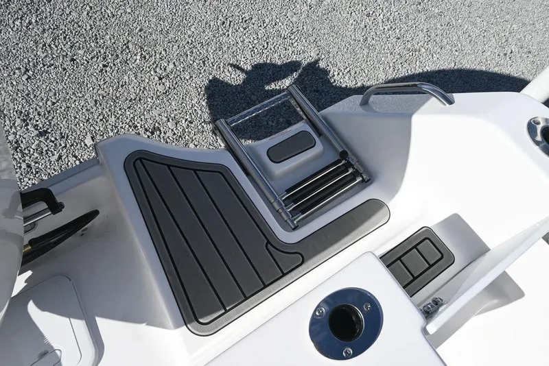 Slide: The Image of 2026 Tidewater 232 CC Adventure boat deck with ladder and grip pads. - 27