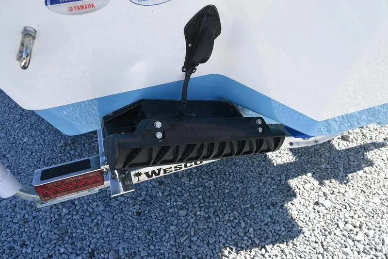Slide: The Image of Tidewater 232 CC Adventure 2026 boat trailer detail on gravel surface. - 8