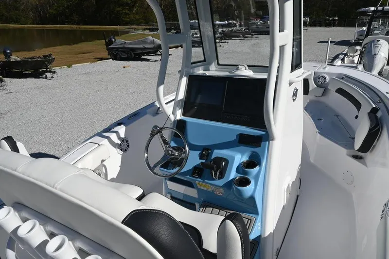 Slide: The Image of 2026 Tidewater 232 CC Adventure boat interior with modern console and seating. - 9