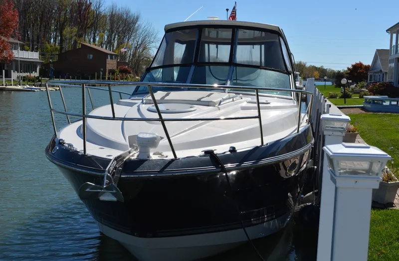 Slide: The Image of 2013 Monterey 340 Sport Yacht docked in a scenic waterfront setting. - 1