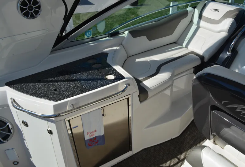 Slide: The Image of Interior of 2013 Monterey 340 Sport Yacht with seating and kitchenette area. - 11