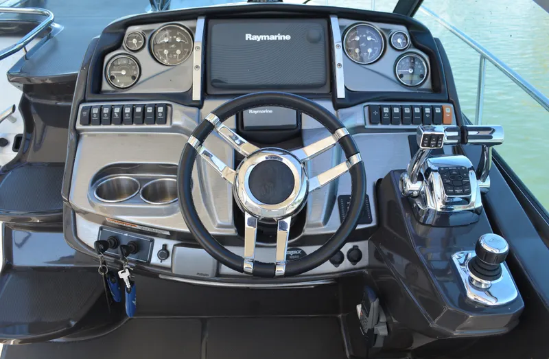 Slide: The Image of Helm of 2013 Monterey 340 Sport Yacht with Raymarine navigation system and modern controls. - 13