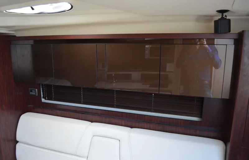 Slide: The Image of Interior of 2013 Monterey 340 Sport Yacht with sleek cabinetry and white seating. - 16
