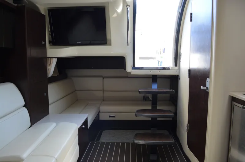 Slide: The Image of Interior of 2013 Monterey 340 Sport Yacht with seating, TV, and stairs. - 20