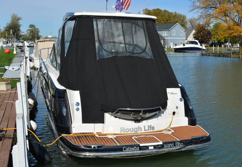 Slide: The Image of 2013 Monterey 340 Sport Yacht docked, rear view with black cover, "Rough Life" text visible. - 4