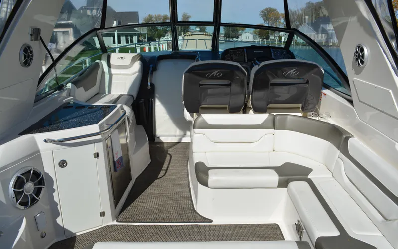 Slide: The Image of 2013 Monterey 340 Sport Yacht interior with seating and helm, showcasing luxury design. - 9